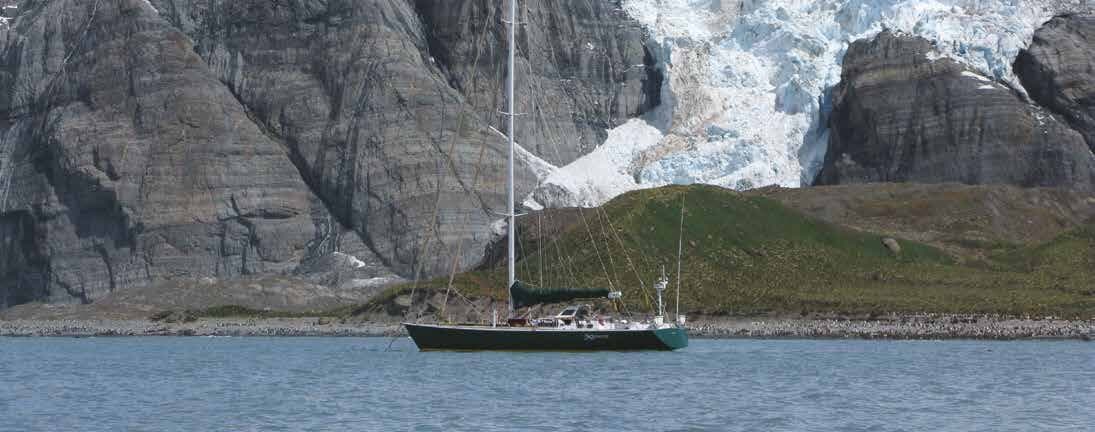 Expedition yacht anchored beneath a glacier